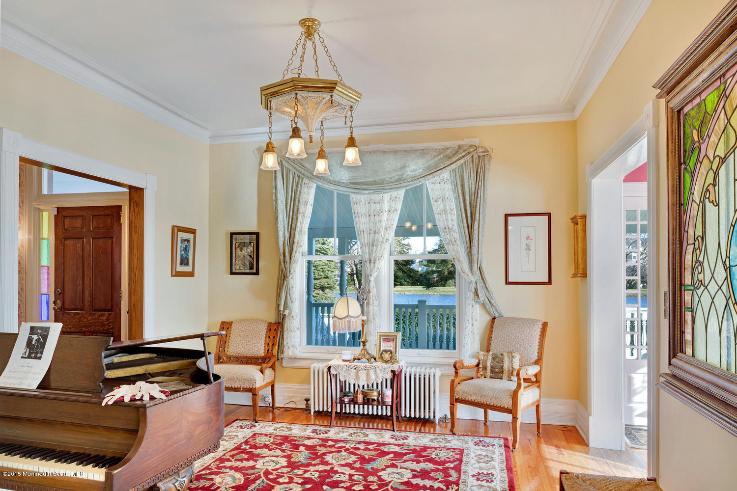 203 East Lake Avenue Spring Lake, NJ 07762 - Photo 9 of 55 a living room with furniture and a chandelier