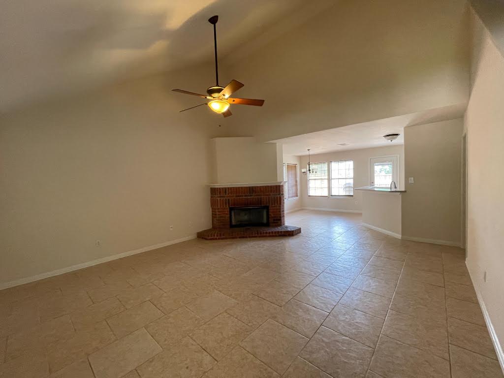 2623 Eastwood Lane Round Rock, TX 78664 - Photo 2 of 12 a view of empty room with a fireplace and fan