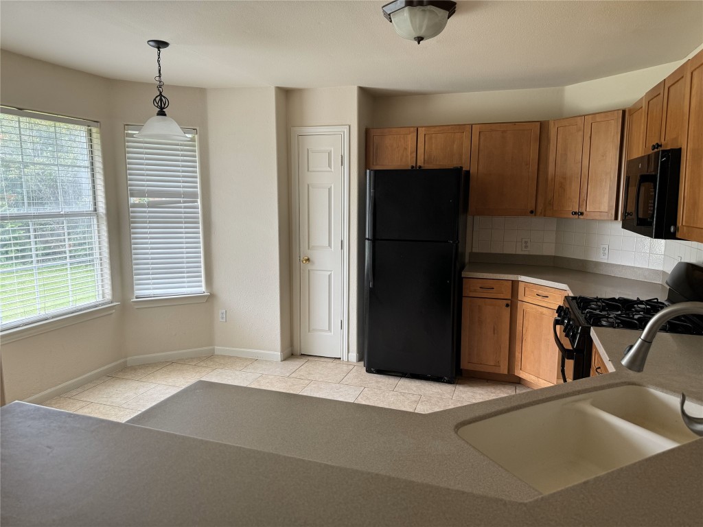 2623 Eastwood Lane Round Rock, TX 78664 - Photo 4 of 12 a kitchen with stainless steel appliances granite countertop a refrigerator and a sink