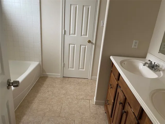 a bathroom with a sink a bath tub and a sink