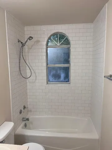 a bathroom with a shower and a bath tub