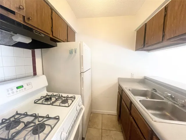 a kitchen with a sink a stove and refrigerator