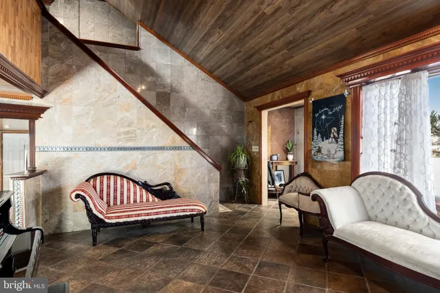 a balcony with chairs and wooden floor