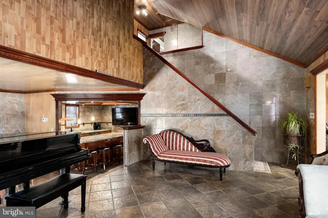 a kitchen with granite countertop kitchen island stainless steel appliances a sink stove and cabinets