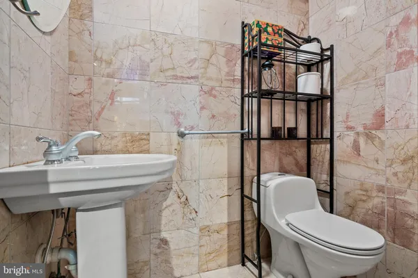 a bathroom with a toilet sink and shower