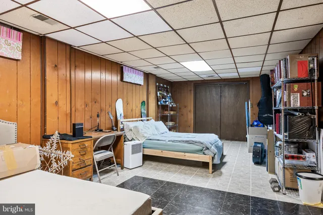 a front view of a house with a snow on the road
