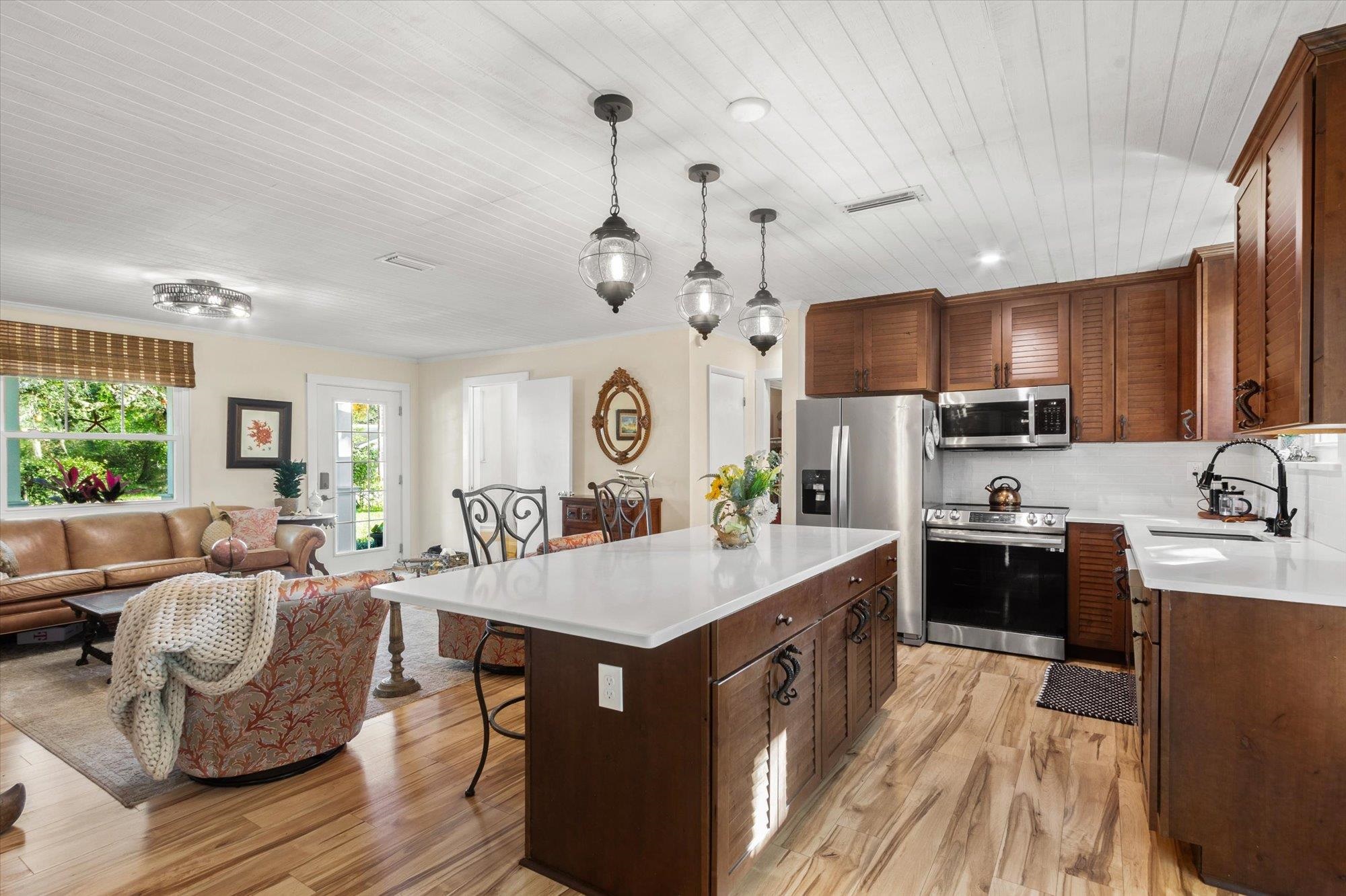 120 Swallow Road St. Augustine, FL 32086 - Photo 8 of 42 a large kitchen with kitchen island a large counter space a sink stainless steel appliances and cabinets