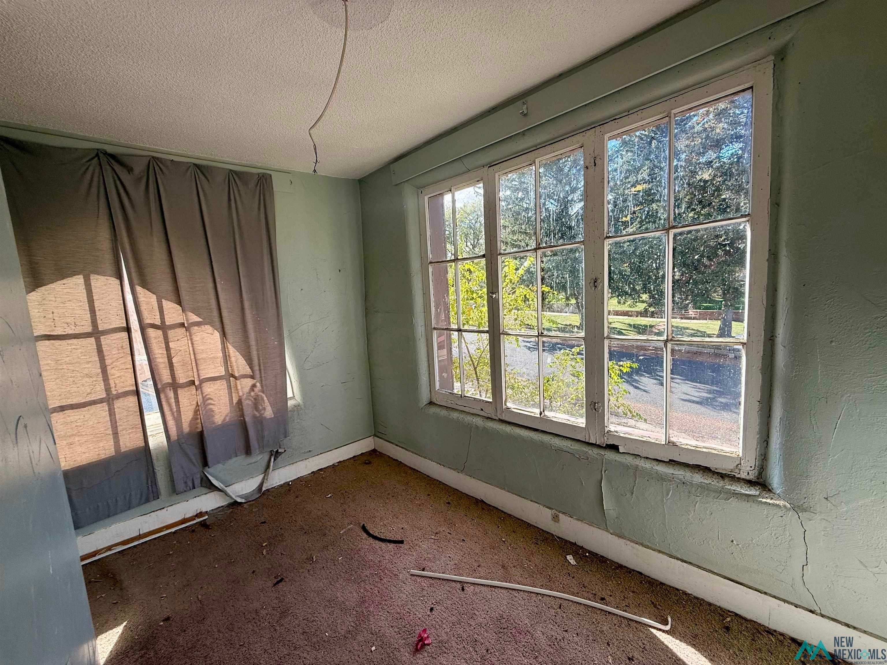 625 South 5th Street Raton, NM 87740 - Photo 6 of 45 Empty room featuring a textured ceiling