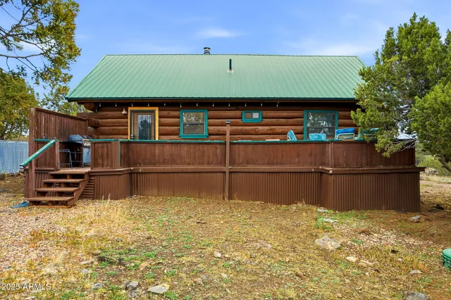 a bedroom with a bed window and a flat screen tv
