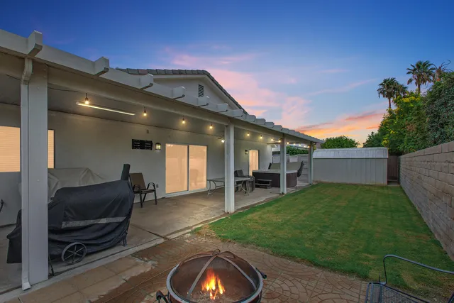 a view of a porch with furniture and a backyard