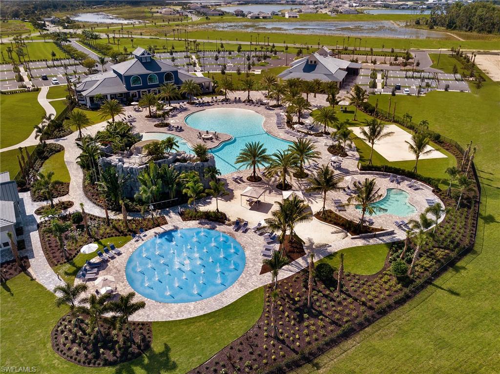 19396 Elston Way Estero, FL 33928 - Photo 10 of 14 a view of a swimming pool with a lot of trees in the background