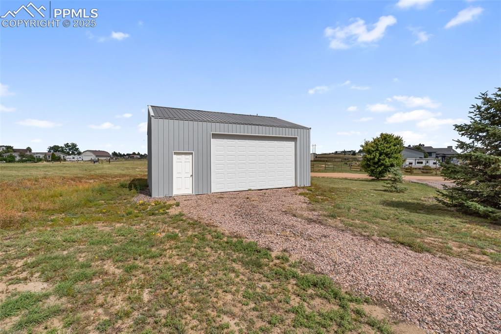 18895 Sage Crest Road Peyton, CO 80831 - Photo 37 of 38 a view of a big room with floor to ceiling windows and yard
