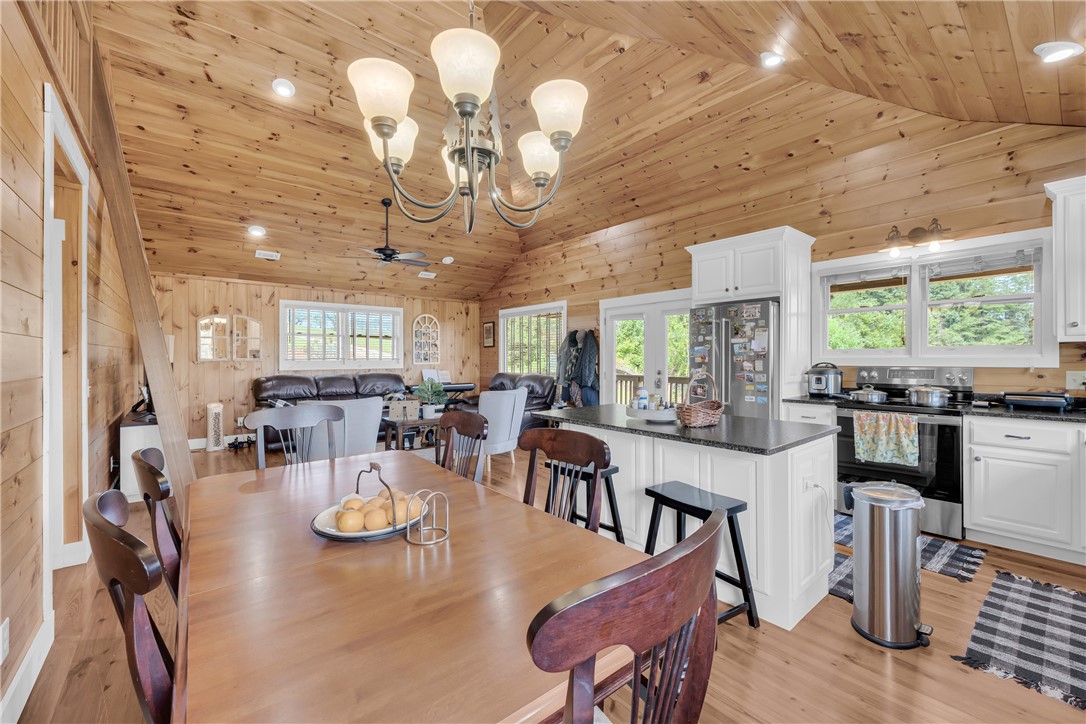 498 Raines Road Mountain Rest, SC 29664 - Photo 30 of 48 Warm wood paneling wraps this open living space beneath a vaulted tongue-and-groove ceiling.