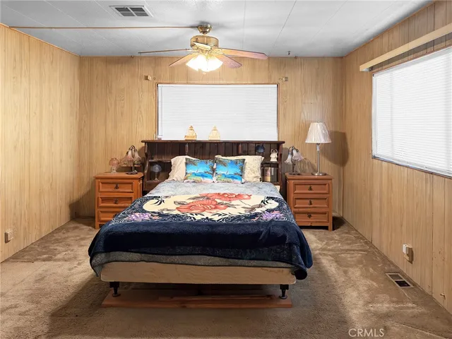 a bedroom with a bed a window and dresser