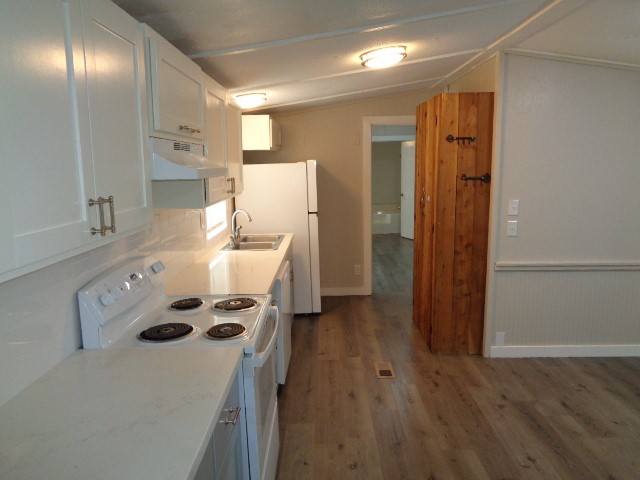 15120 Capitol Hill Road Montgomery, TX 77316 - Photo 7 of 17 a kitchen that has a sink a refrigerator and a stove top oven