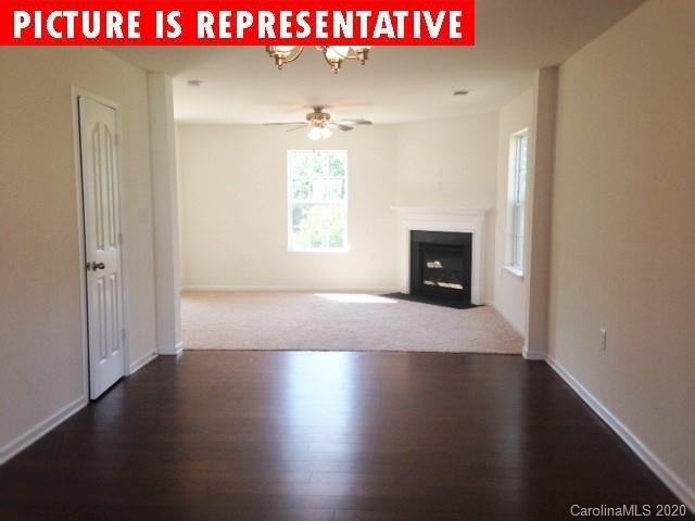 710 Xander Drive, Unit 45 Charlotte, NC 28214 - Photo 11 of 18 an empty room with wooden floor and windows