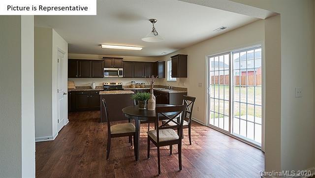 710 Xander Drive, Unit 45 Charlotte, NC 28214 - Photo 15 of 18 a view of a dining room with furniture window and wooden floor