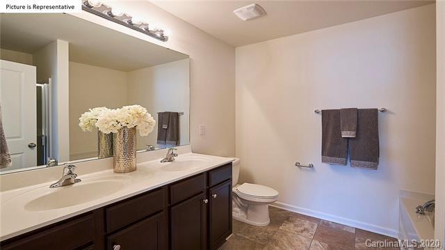 710 Xander Drive, Unit 45 Charlotte, NC 28214 - Photo 16 of 18 a bathroom with a toilet sink and mirror