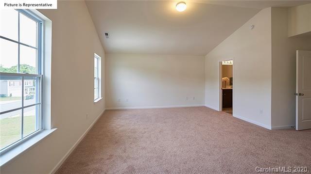 710 Xander Drive, Unit 45 Charlotte, NC 28214 - Photo 17 of 18 an empty room with windows and entrance to other room