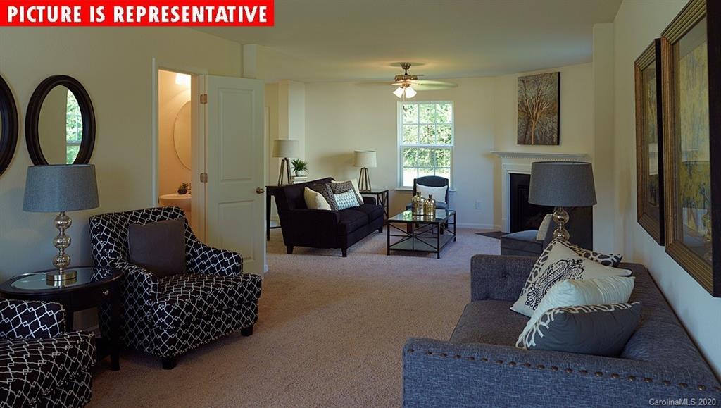 710 Xander Drive, Unit 45 Charlotte, NC 28214 - Photo 8 of 18 a living room with furniture and a fireplace
