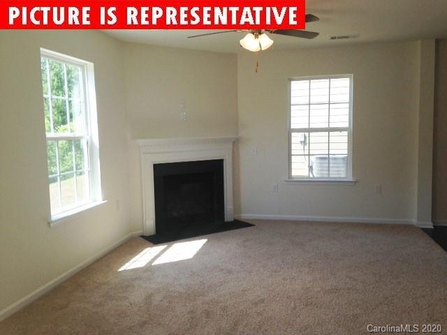 710 Xander Drive, Unit 45 Charlotte, NC 28214 - Photo 10 of 18 a view of an empty room with a window and fireplace