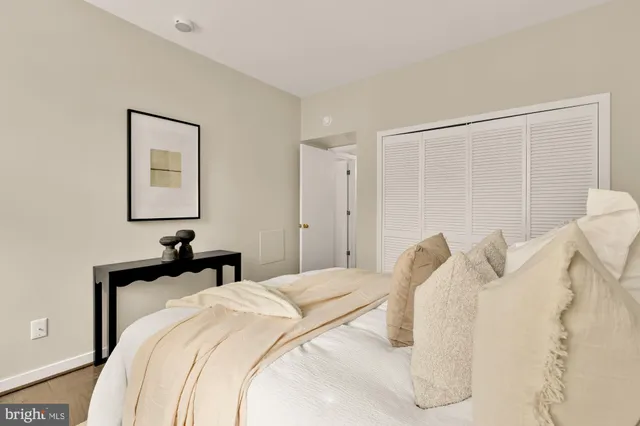 a bedroom with a bed and a lamp