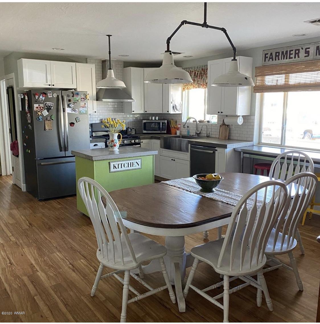 241 West Center Street Snowflake, AZ 85937 - Photo 5 of 25 a kitchen with stainless steel appliances granite countertop a dining table and chairs