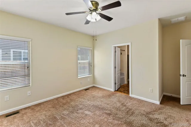 a white bath tub sitting next to a white sink and vanity