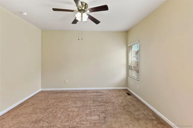 a backyard of a house with fire pit and couch