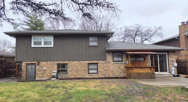 a house that has a tree in front of it
