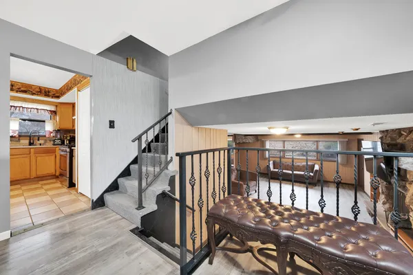 a view of a hallway with wooden floor and staircase