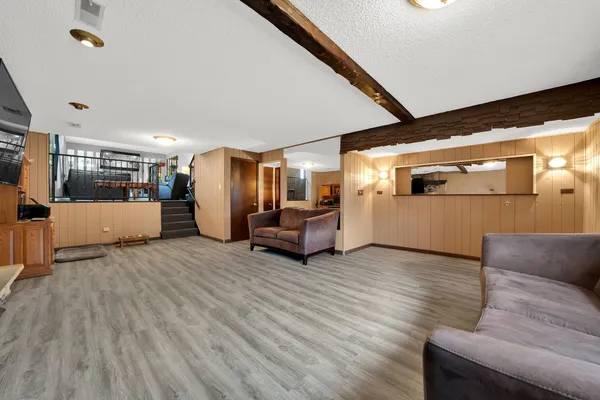 a living room with furniture and kitchen view