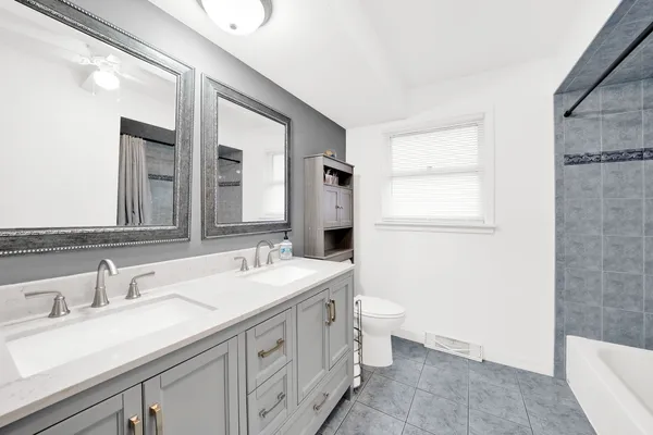 a bathroom with a double vanity sink and a mirror