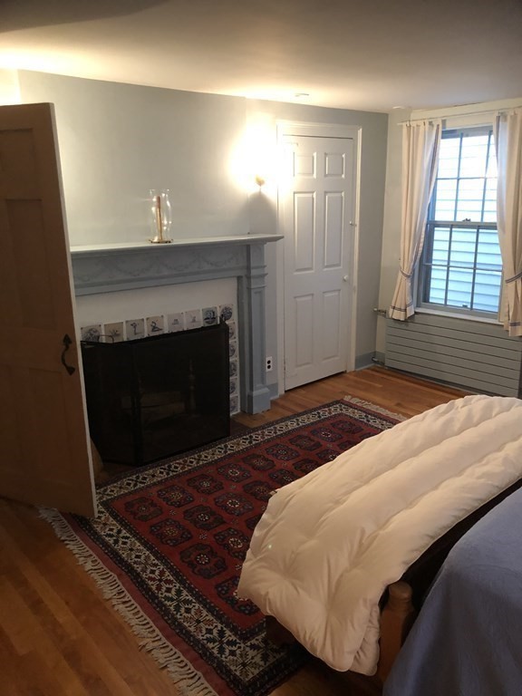 55 Park Street Boston, MA 02129 - Photo 13 of 24 a bedroom with a bed and a fireplace
