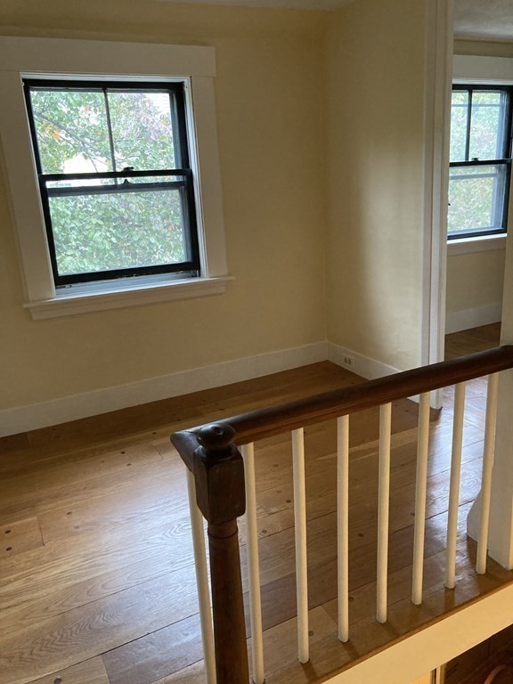 55 Park Street Boston, MA 02129 - Photo 17 of 24 a view of a hallway with wooden floor and a window