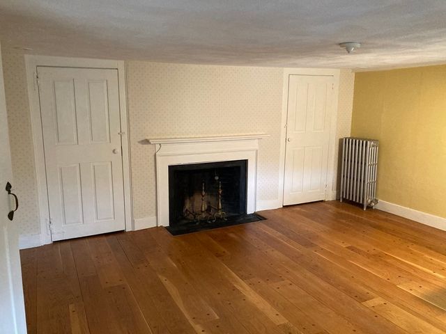 a view of empty room with a fireplace