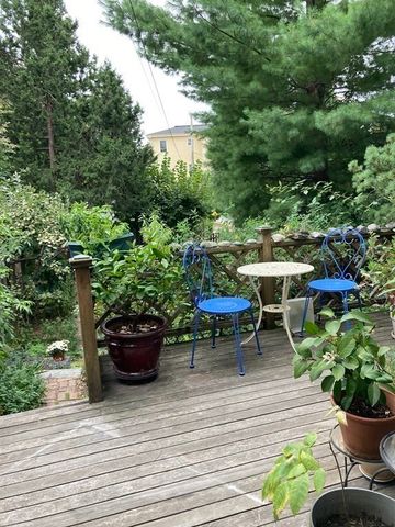 a view of a table and chairs in back yard of the house