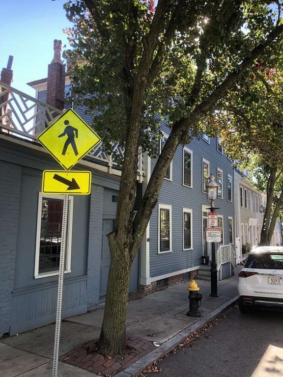 55 Park Street Boston, MA 02129 - Photo 2 of 24 a view of a house with a cars park fire pit and a large tree