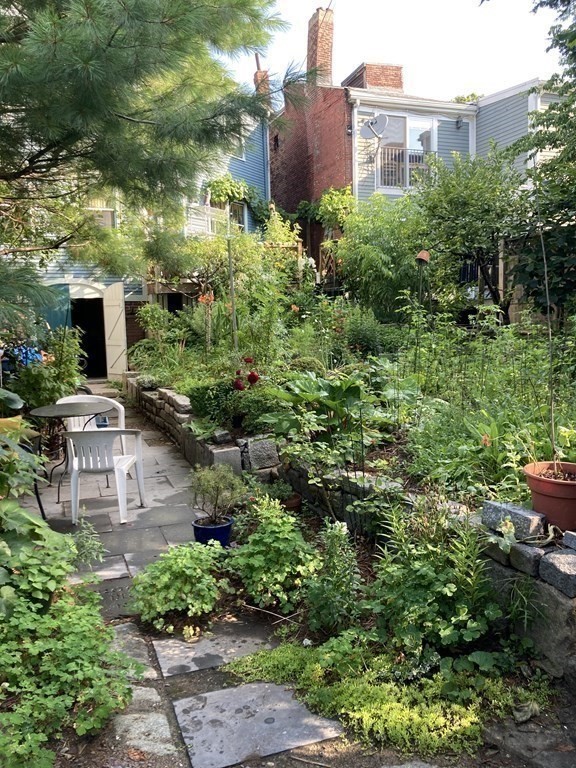 55 Park Street Boston, MA 02129 - Photo 22 of 24 a view of a garden with plants and bench
