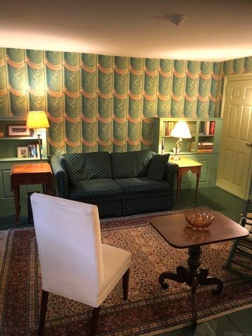 a living room with furniture and lamp