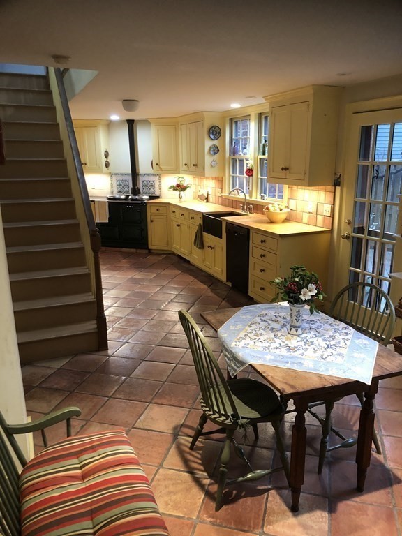 55 Park Street Boston, MA 02129 - Photo 7 of 24 a open dining room with stainless steel appliances kitchen island granite countertop a table chairs and a refrigerator