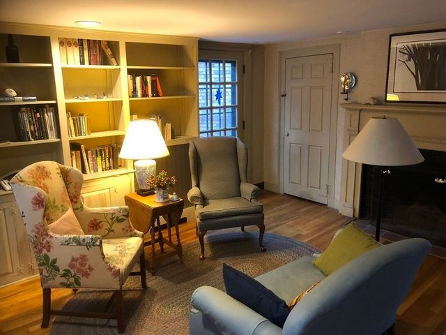 a living room with furniture a lamp and a window
