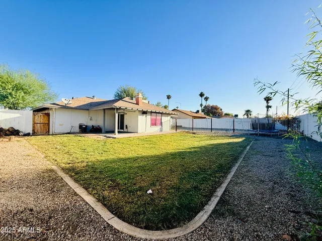 a swimming pool with outdoor seating and yard