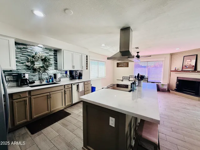 a kitchen with a sink cabinets and wooden floor