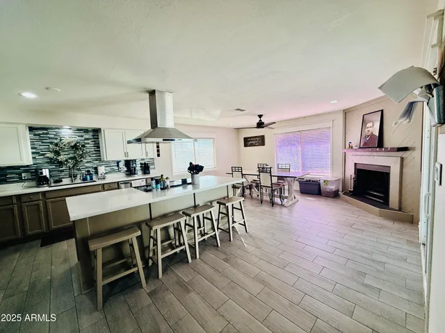 a large white kitchen with lots of counter space a sink and appliances