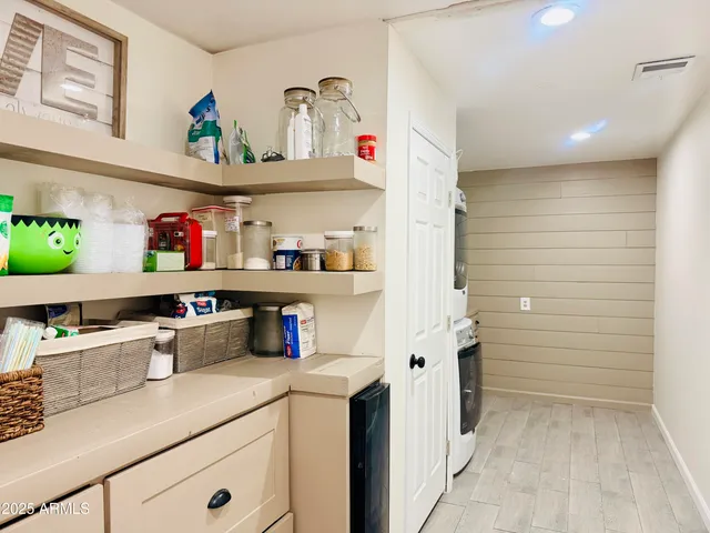 a kitchen with stainless steel appliances cabinets and a window