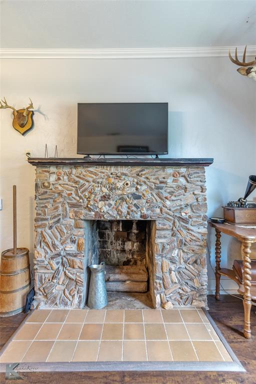 202 East Ross Street Rising Star, TX 76471 - Photo 11 of 40 a living room with a fireplace and a fireplace
