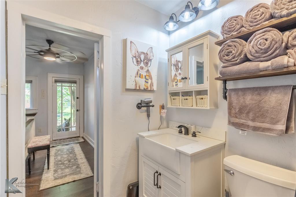 202 East Ross Street Rising Star, TX 76471 - Photo 25 of 40 a bathroom with a sink a toilet and a mirror