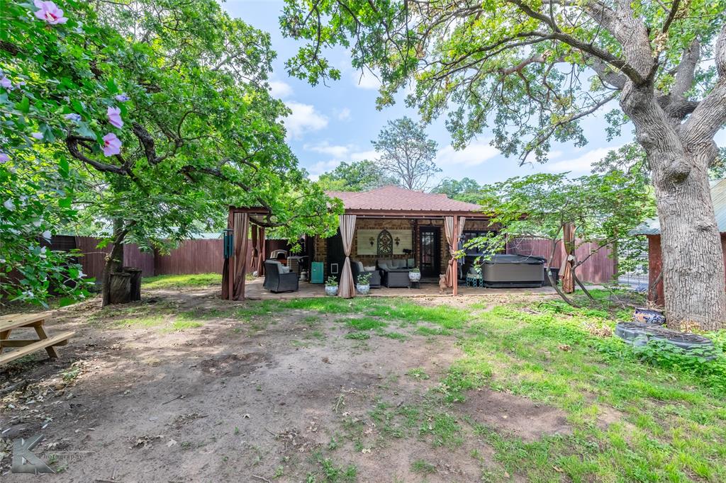 202 East Ross Street Rising Star, TX 76471 - Photo 34 of 40 a view of a table and chairs in backyard of the house