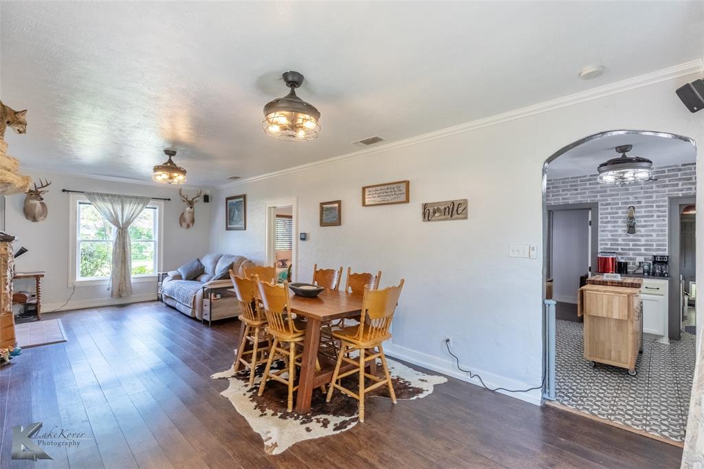 202 East Ross Street Rising Star, TX 76471 - Photo 7 of 40 a view of a dining room with furniture window and wooden floor